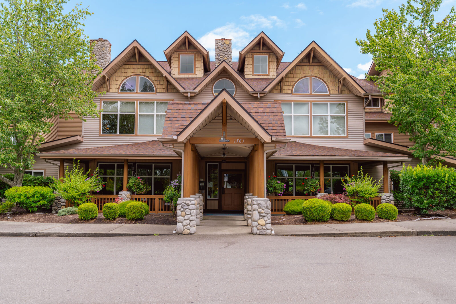 A charming, multi-story building with a welcoming entrance and landscaped surroundings.